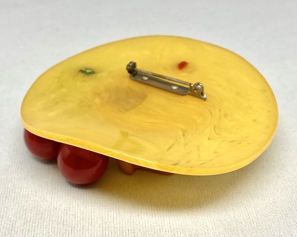 BP157 butterscotch bakelite figural hat pin with red cherries
